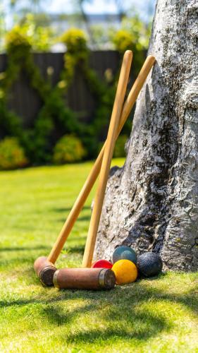 a group of baseball bats laying on the grass at Hotel Montreal in Christchurch