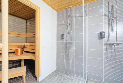 a shower in a bathroom with a glass shower stall at Holiday Club Saariselkä Superior Apartments in Saariselka