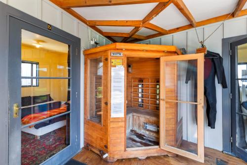 a tiny house with a door and a bedroom at Raglan Backpackers in Raglan