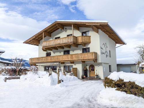 a house with a balcony in the snow at Haus Chorblick in Westendorf