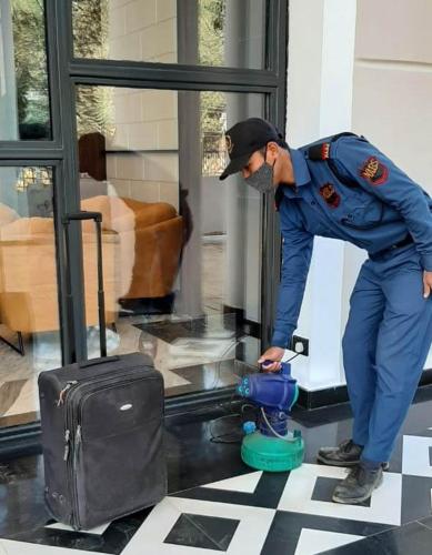 a man in uniform standing next to a fire hydrant at Hotel Polo Towers Agartala in Agartala