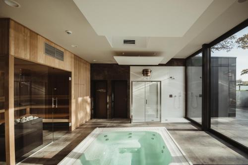 a bathroom with a jacuzzi tub in the middle at Golden Lakes Hotel in Boussu-lez-Walcourt