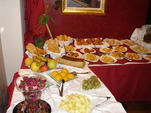 a table with many different types of food on it at Hotel Iris in Granollers