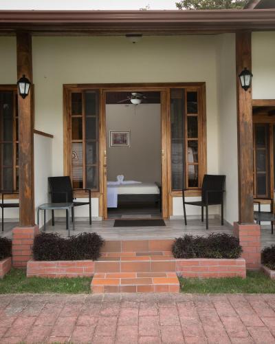 a patio with two chairs and a table in a building at Panama Camping Park Boquete in Boquete