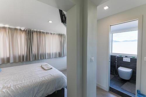 a bedroom with a bed and a bathroom with a window at La Terrasse du Port AP4212 in Nice