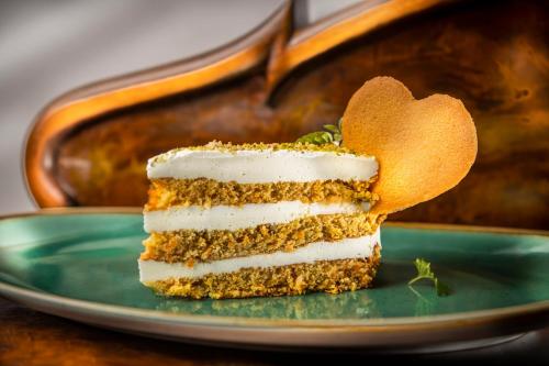 a piece of cake on a plate with a heart at Hotel Kaj in Marija Bistrica