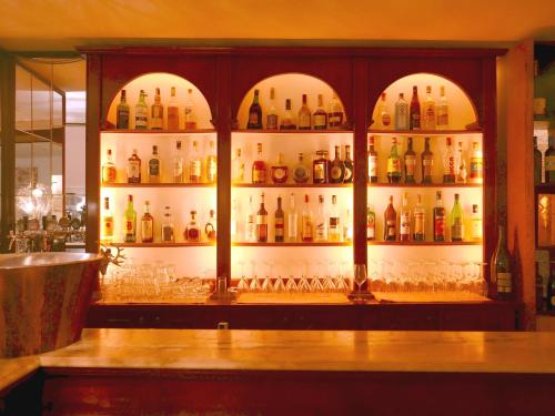 a bar with a lot of bottles of alcohol at Hotel Paradiso in Asiago