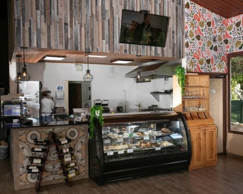 a bakery with a counter with a lot of food at Panama Camping Park Boquete in Boquete