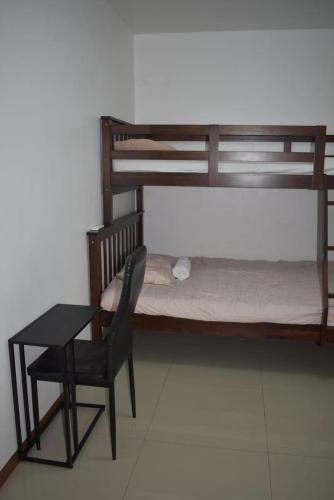 a bedroom with a desk and a bed and a chair at Affordable Makati APT in Manila
