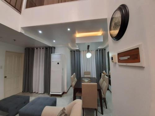 a living room with a kitchen and a dining room at Affordable Makati APT in Manila