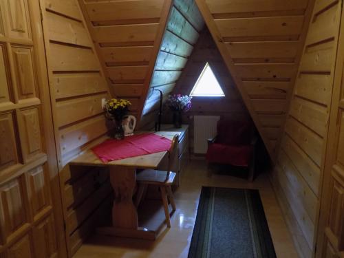 an attic room with a table and a window at Pokoje u Teresy in Czarna Góra