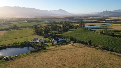 an aerial view of a house in the middle of a field at Raptor Rise in Tulbagh