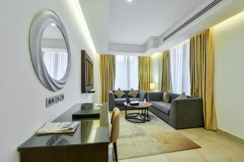 a living room with a couch and a table at Downtown Hotel Apartments in Amman
