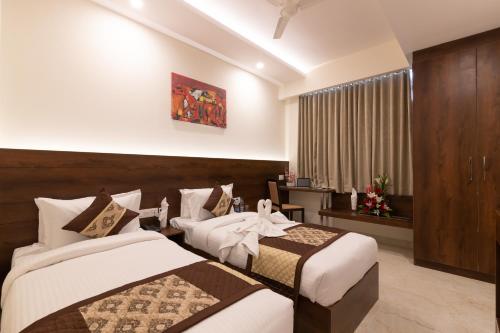 a hotel room with two beds and a window at Mojatel By Icon in Bangalore