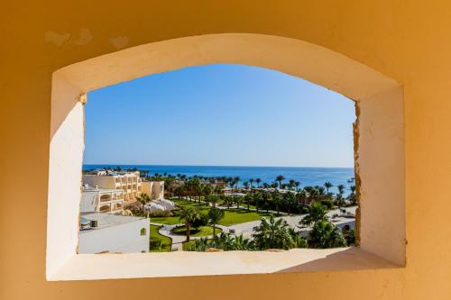 a window view of the beach from a building at Brayka Bay Reef Resort in Abu Dabab
