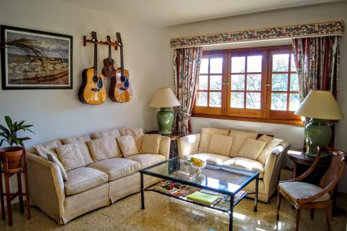 a living room with two couches and a glass table at La Vista Verde in Teror