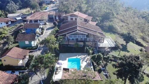 an aerial view of a house on a hill at Chalé Condominio Linda Vista in Penedo