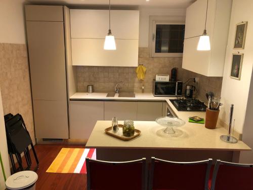 a kitchen with white cabinets and a counter top at Cozy Apartment Barzio in Barzio