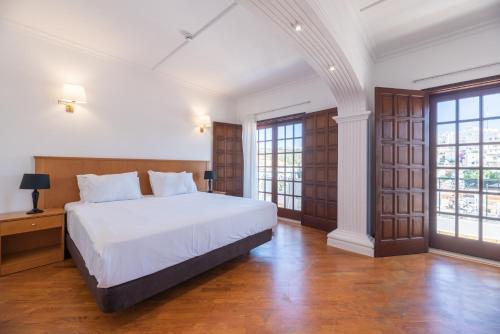 Una cama o camas en una habitación de Bertolina Guest House