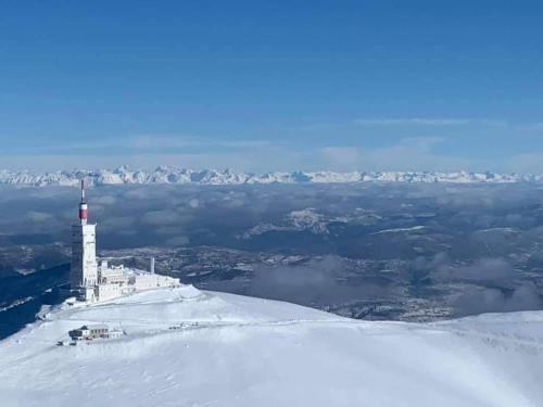 a lighthouse on the top of a snow covered mountain at Chambres entre Ventoux et luberon in Sault-de-Vaucluse