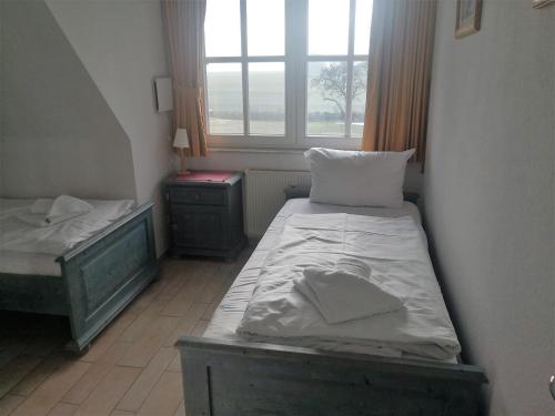 a small room with two beds and a window at Das Landhaus am Haff LHH B06 in Stolpe