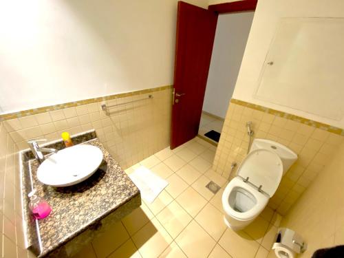 a bathroom with a sink and a toilet at DXB Backpackers in Dubai