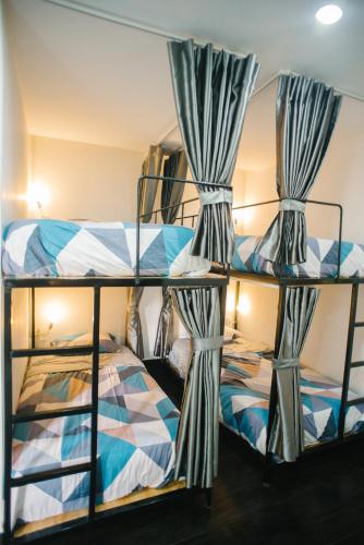 a bunk bed room with two bunk beds with curtains at Thung Lũng Mơ - Dream Valley in Khu Chi Lăng