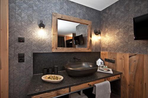 a bathroom with a sink and a mirror at Villa Michaela in Gerlos