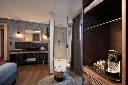 a bedroom with a bathroom with a shower and a sink at Villa Michaela in Gerlos