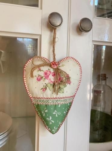 a heart shaped ornament on a door of a cabinet at Villa Miranda in El Rompido