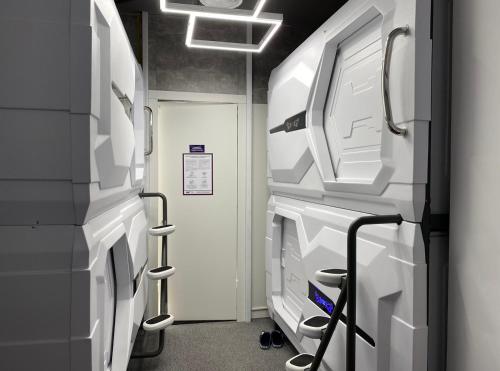 an empty hospital room with machines and a hallway at AV-1 Capsule Hotel in Kyiv