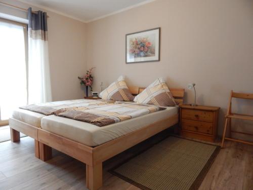 a bedroom with a large bed in a room at Ferienwohnungen Stark in Kelheim