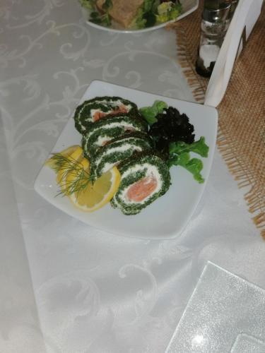 a plate of sushi and vegetables on a table at Restauracja Rycerska in Iłża