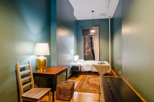 a bedroom with a bed and a table and a chair at Lamartine Chelsea in New York