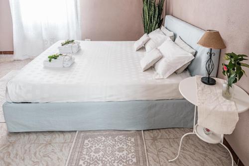 a bedroom with a large bed with white sheets and pillows at Villa Curte Nicia in Nizza Monferrato