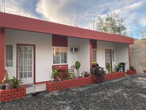 a small house with a red roof at Doroteo's Transient House in Calingcuan