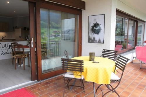a yellow table and chairs on a patio at KuckucksLockennest in Seebach