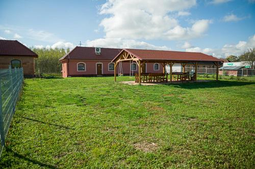 a large yard with a house and a grass field at Penzion Sudomír in Sudoměřice