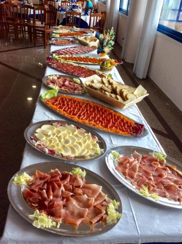 a long table filled with different types of food on plates at Hotel San Gaetano in Grisolia
