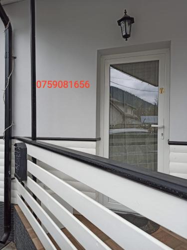 a front porch of a house with a door at Cazare Moldi Btt in Câmpulung Moldovenesc