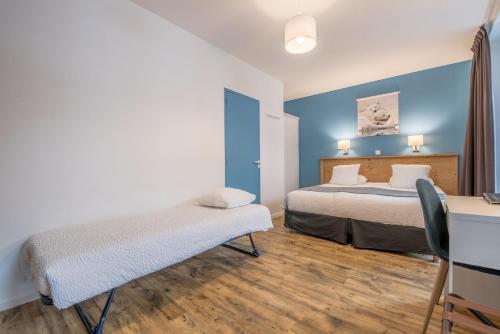 Letto o letti in una camera di Hôtel Le Marintan