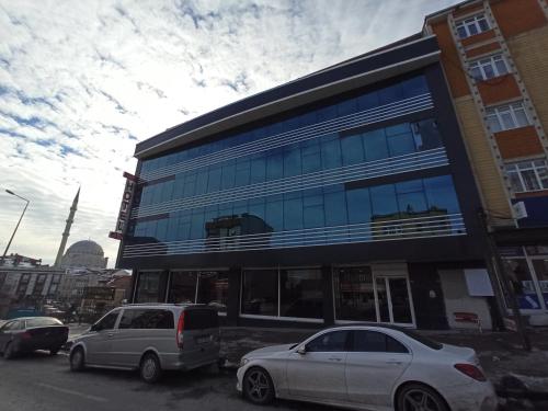 cars are parked in front of a building at Skylon Airport Hotel in Arnavutköy