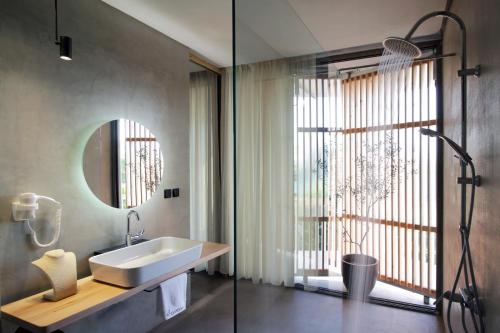 a bathroom with a sink and a mirror at ecoSuites in Toroni