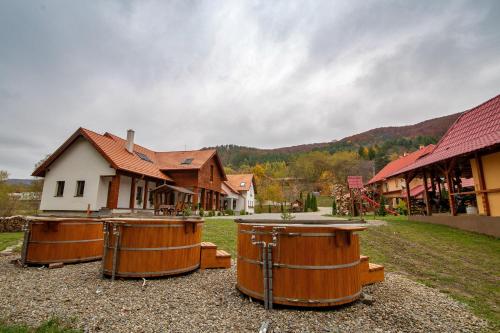 a group of barrels sitting in front of a house at Patakmenti Panzió Spa in Corund