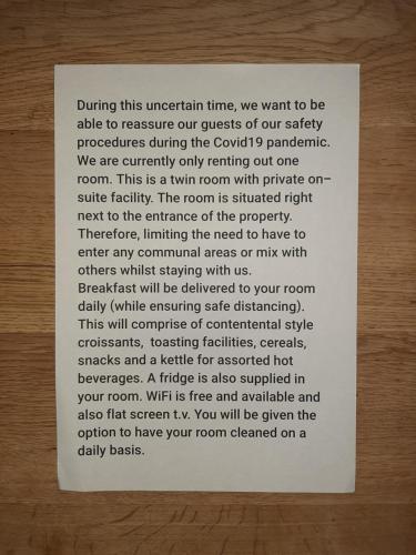 a poem on a piece of paper on a wooden table at Nest Guesthouse in Margate