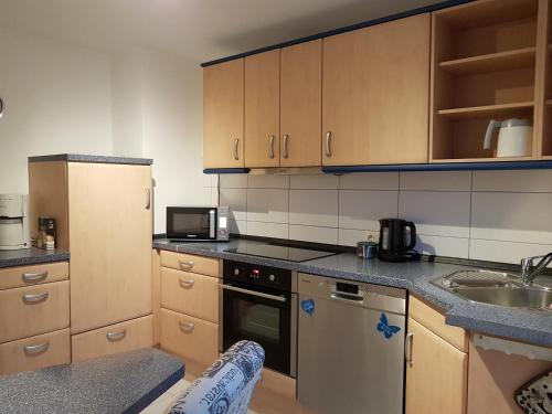 a kitchen with a sink and a stove top oven at Ferienwohnung- SARAH in Hahnstätten