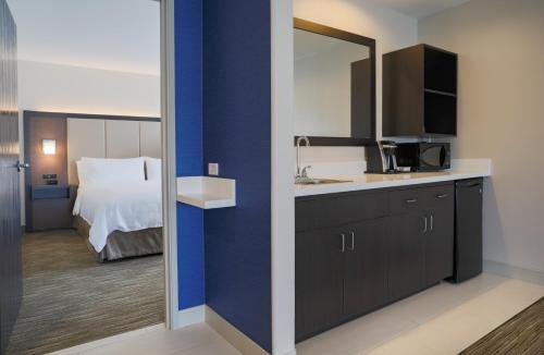 a room with a bed and a sink and a mirror at Holiday Inn Express Prescott by IHG in Prescott