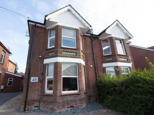 a red brick house with white windows at Beddoe Apartments Premier Lodge Eastleigh near Winchester and Southampton in Eastleigh