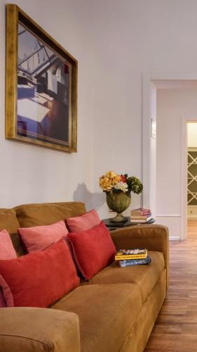 a living room with a brown couch with red pillows at Alecrim ao Chiado in Lisbon