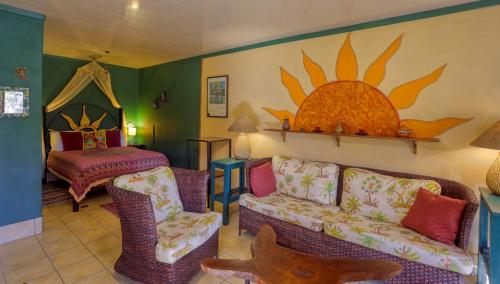 a living room with a couch and a bed at Lucky Bug Bed And Breakfast in Nuevo Arenal